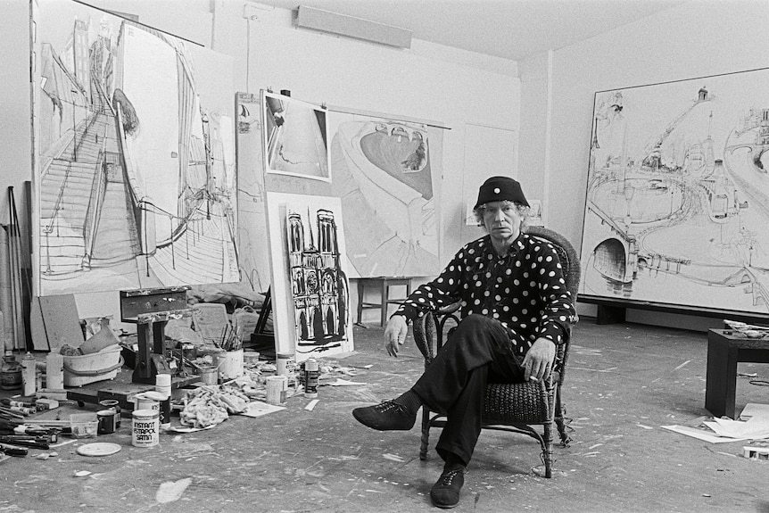 A black and white photo of Brett Whiteley in his studio.