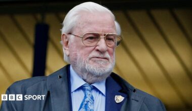 Former Chelsea and Leeds United owner Ken Bates in light blue shirt and tie, with a Chelsea club badge on his jacket