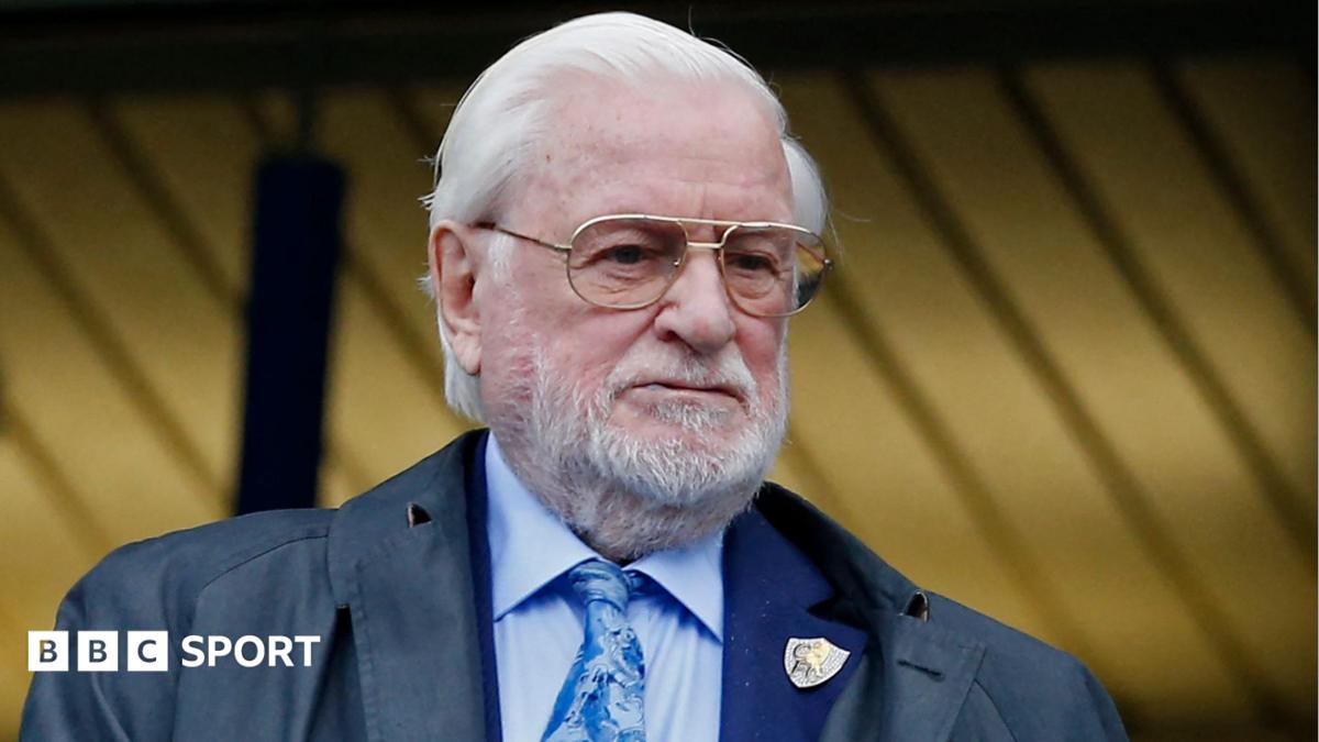 Former Chelsea and Leeds United owner Ken Bates in light blue shirt and tie, with a Chelsea club badge on his jacket