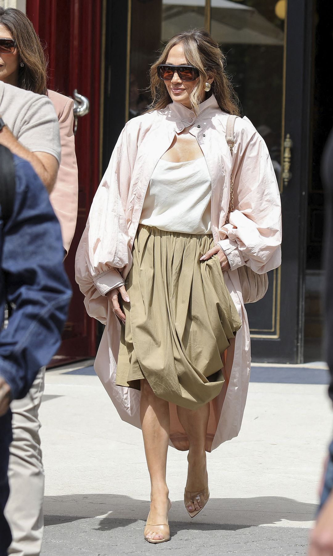 Jennifer Lopez looks stunning in a pale pink oversized jacket paired with a mustard draped skirt.