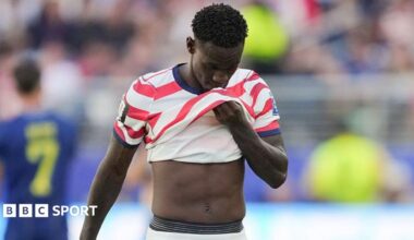Folarin Balogun covers his face with his shirt after being sent off