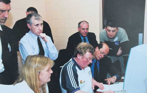 Bill Kenneally (pictured centre using keyboard) working as a tallyman at an election count in the Butler Community Centre