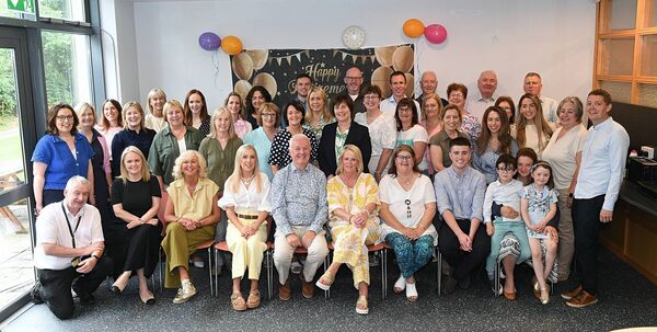 John Hanily (centre) pictured with family, friends and colleagues at a coffee morning to mark his retirement after 45 years. Pic: Gerard O’Loughlin