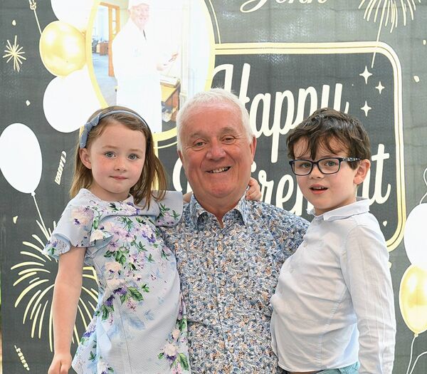 John Hanily with his grandchildren Felicity and Marcus Hanily on his retirement from the HSE after 45 years. Pic: Gerard O’Loughlin