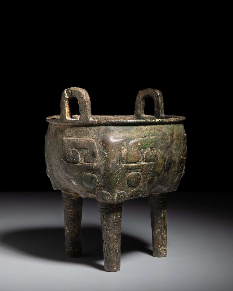 A late Shang-style archaic bronze tripod vessel known as a ding.
