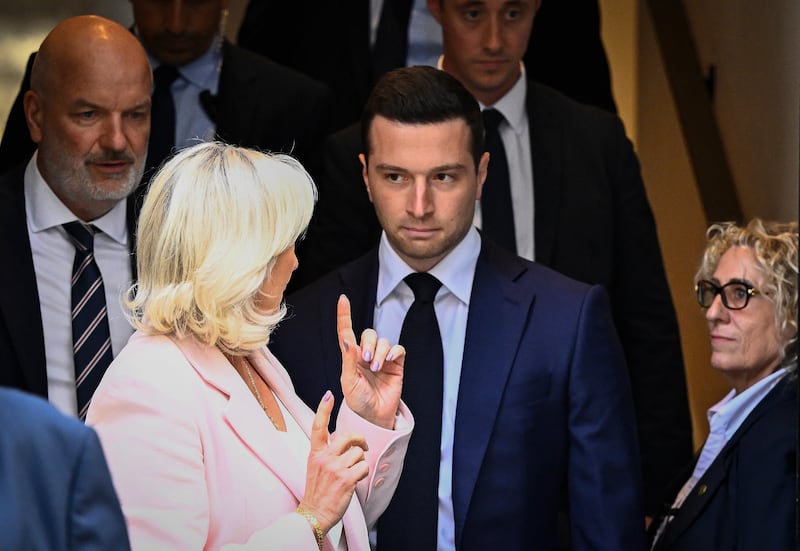 Jordan Bardella (centre) and Le Pen leave the National Rally's new headquarters following a meeting in Paris on Tuesday. Photograph: Julien De Rosa/AFP via Getty Images
