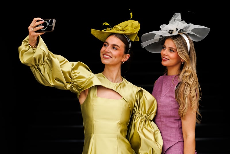 Leah Hoey and Jamie O'Grady pause for a selfie during Ladies Day at the Galway Races. Photograph: James Crombie/INPHO