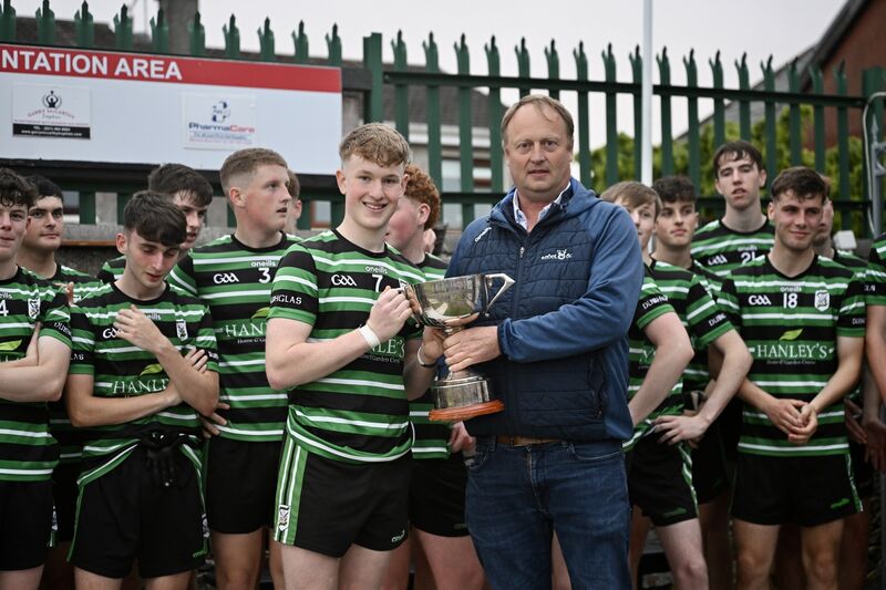  Celebrations for Douglas, captained by James Gordon, as he is presented with the cup by Peter Watson of Rebel Og after the win in the Rebel Og Fe18 Premier 1 League Football final: Douglas vs Carrigaline at Ballinlough, Cork. Picture: Larry Cummins