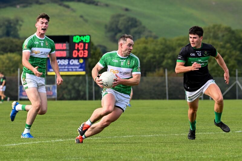 Aghabullogue's John Corkery breaks forward chased by Nemo Rangers' Oisín White. Picture: Chani Anderson