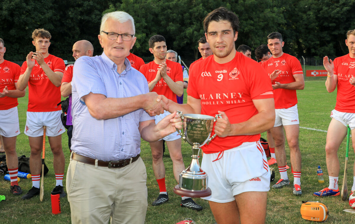 Cork County Board Children's Officer Donal McCarthy presents the John Mullins Trophy to Blarney captain Patrick Crowley after they defeated Ballinhassig in the Red FM Division 3 Hurling League final at Ballincollig. Picture: David Creedon