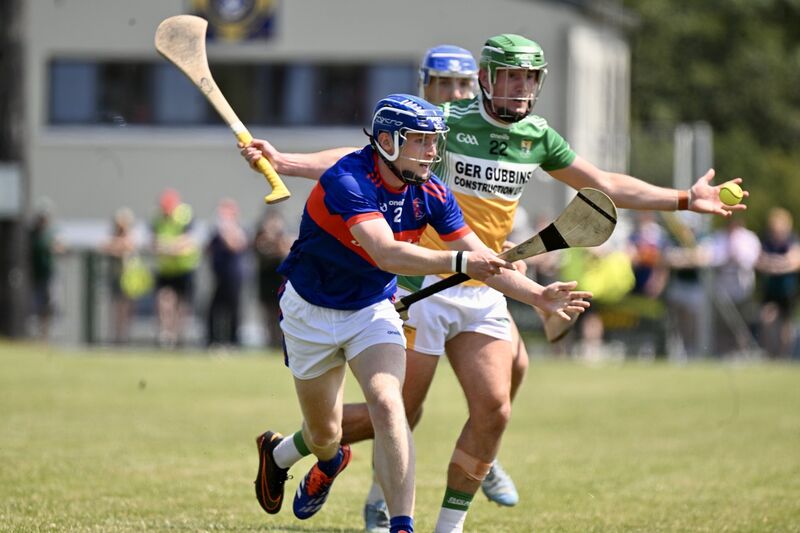 Erin's Own's Cian Dunphy is challenged by Bride Rovers' Brian Roche. Picture: Larry Cummins