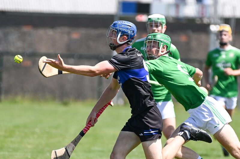  Sarsfields' Sam McNamara gets his pass away under pressure from Aghada's Ronan Murphy during their Division 6 Hurling League final in Cobh. Picture: David Keane.