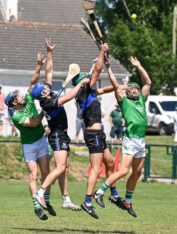  Aghada's William Leahy and John Looney battle for a dropping ball with Sarsfields' Paul Leopold and Ronan Barry. Picture: David Keane.