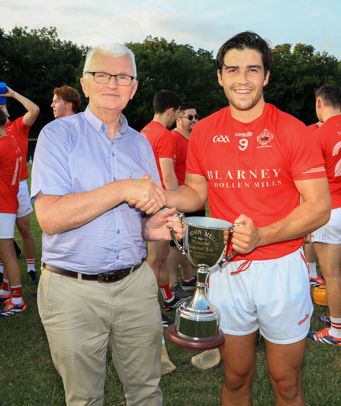 Cork County Board Children's Officer Donal McCarthy presents the John Mullins Trophy to Blarney captain Patrick Crowley after they defeated Ballinhassig in the RedFM Division 3 Hurling League final. Picture: David Creedon