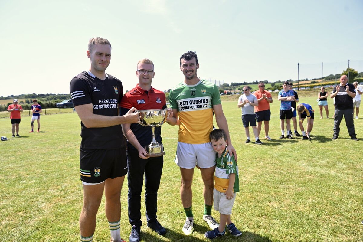 Lochlann Ryan, aged four,  joins Bride Rovers co-captains Conleith Ryan and (left) goalkeeper Cian Hogan as they are presented with the cup by Daniel Lane, operations manager, Cork County Board. Picture: Larry Cummins