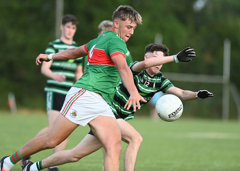 Clon's Ewan Knowles gets his shot away despite the efforts of Tomás Reddington. Picture: Martin Walsh