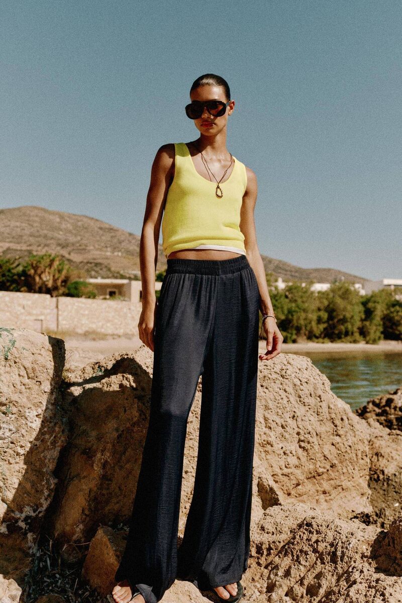 A model posing in Zara's flowy wide-leg trousers