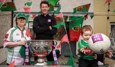 EARLY WARNING: Former Mayo Star David Clarke alongside Dorothy McDonnell and Matthew Carr, aged 4, pictured in Ballina for AIB ahead of the 2026 GAA All-Ireland Senior Football Championship Finals. Pic: ©INPHO/Dan Sheridan.