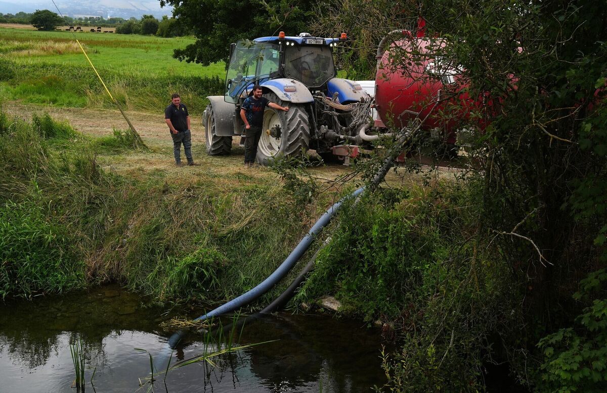 Local farmers fill tankers of water from the River Anner for spreading at ground level in an effort to tackle major wildfire as it continues to burn at Slievenamon in Co Tipperary. Picture: Brian Lawless/PA Wire
