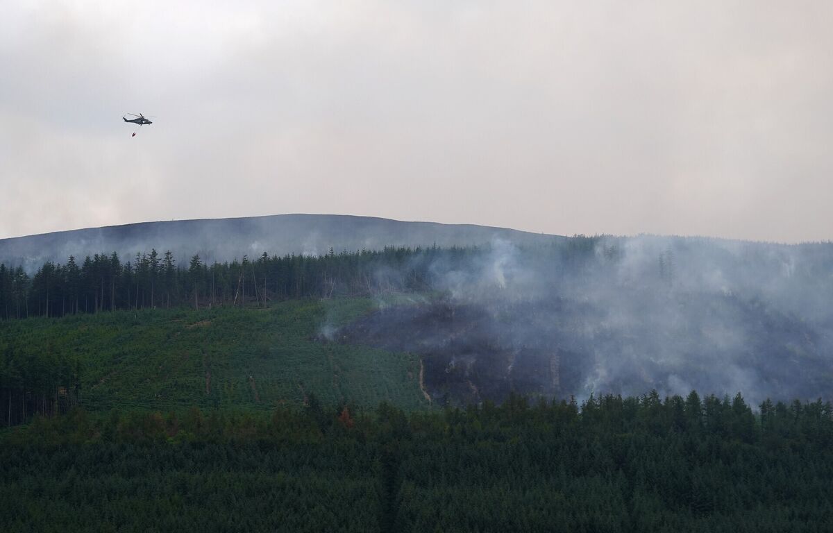 Members of the Irish Air Corps provide aerial support in tackling a major wildfire as it continues to burn at Slievenamon in Co Tipperary. Picture: Brian Lawless/PA Wire