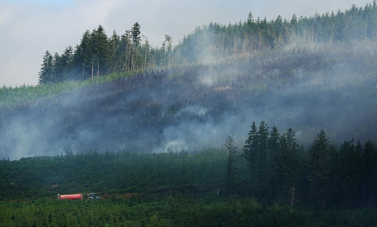 Farmers in in Co Tipperary transporting tankers of water to spread at ground level in an effort to contain the major wildfire at Slievenamon. Picture: Brian Lawless/PA