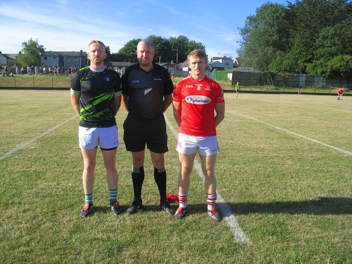 Referee Cormac Dineen accompanied by captains James Kind (Passage) and Shane O'Donovan (Mayfield) before their opening AOS Security Seandún Junior A Football Championship opener 