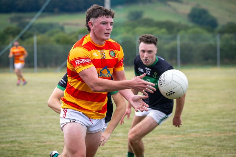 Newcestown’s Daire McAree makes a pass while Nemo Rangers’ Barry Cripps has eyes on the ball. Picture: Chani Anderson