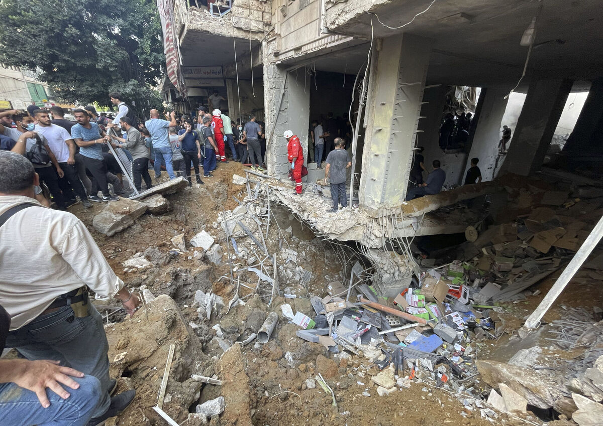 Residents and rescuers gather at the scene of a missile strike in the southern suburbs of Beirut, on Friday, September 20, 2024. Picture: Bilal Hussein/AP