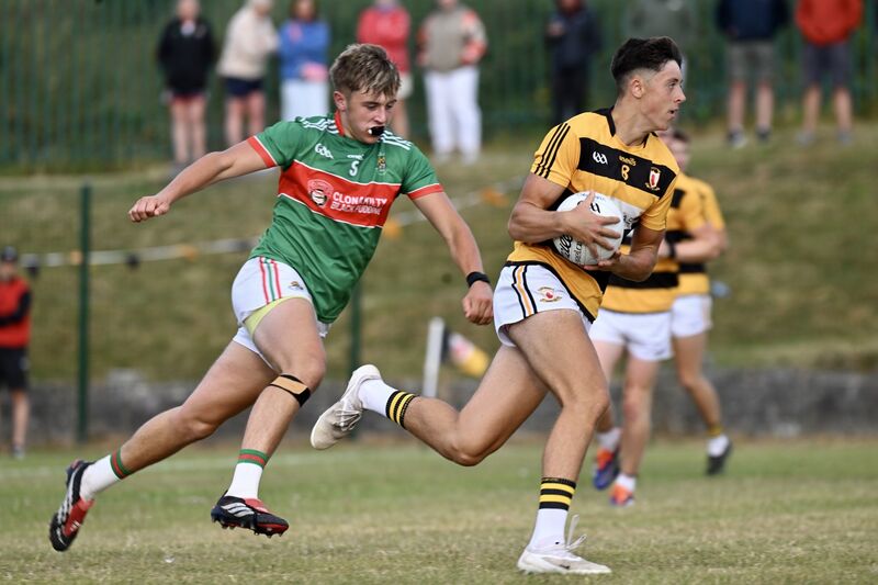  Corey O’Sullivan races through midfield for Na Piarsaigh, chased by Ewan Knowles, Clonakilty. Picture: Larry Cummins