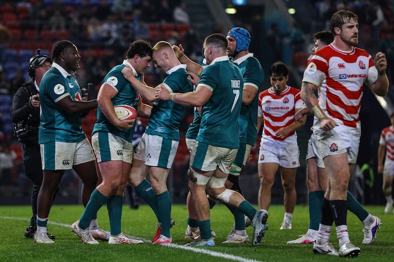 Ireland's Tom Stewart celebrates scoring a try with Nathan Doak and Sam Illo. Photograph: Ben Brady/Inpho