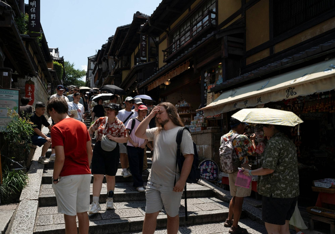 Tourists walk through a traditional alleyway near Kiyomizu-dera temple in Kyoto. Japan. Photo by Reuters