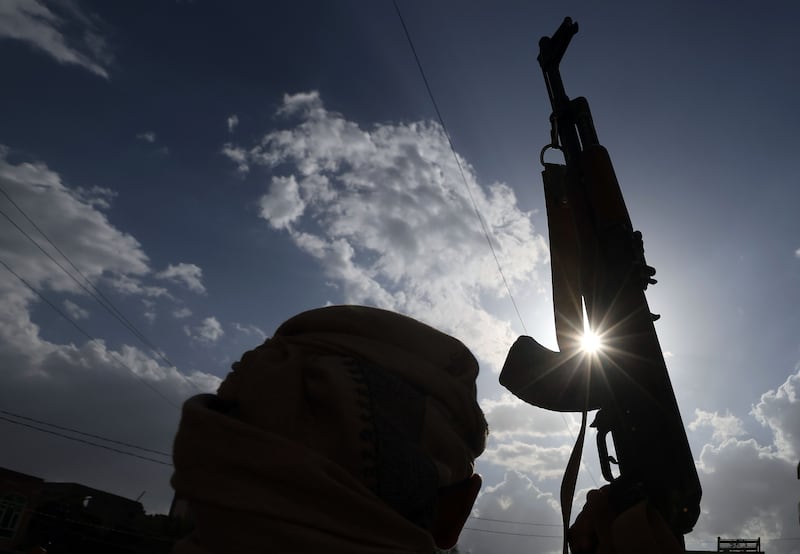 A Houthi supporter in Yemen brandishes a weapon during a protest. The Houthis have launched numerous drone and missile attacks targeting shipping vessels in the Red Sea. Photograph: EPA