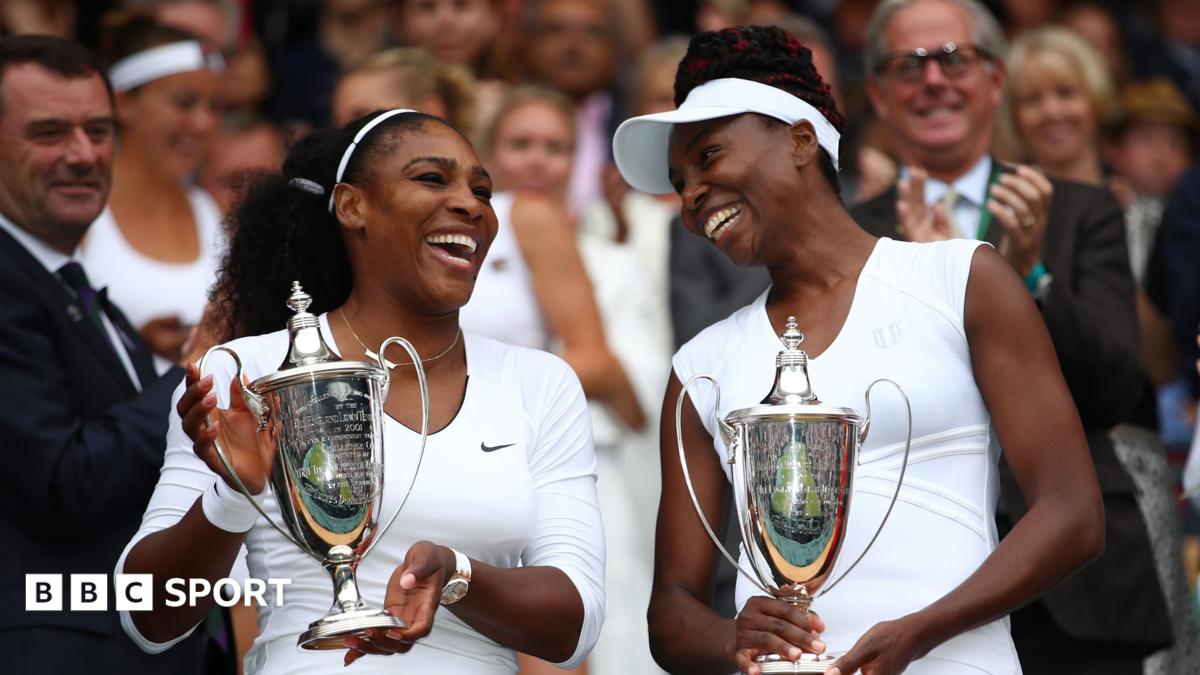 Serena and Venus Williams pose with the women's doubles trophies at Wimbledon in 2016