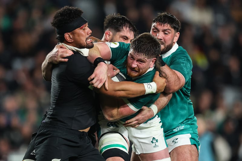 Ireland's Joe McCarthy is tackled by New Zealand's Ardie Savea. Photograph: INPHO/Ben Brady