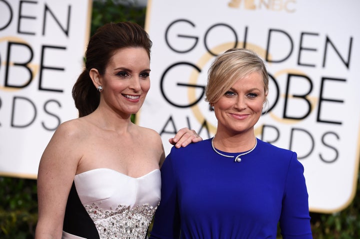 Tina Fey (left) and Amy Poehler arrive at the 72nd annual Golden Globe Awards in 2015.