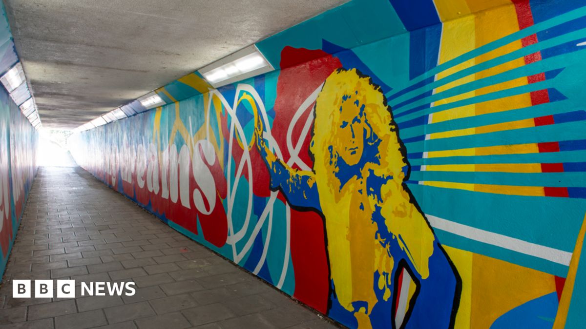 A photo of a colourful mural painted on a subway, which includes an illustration of Led Zeppelin's Robert Plant.