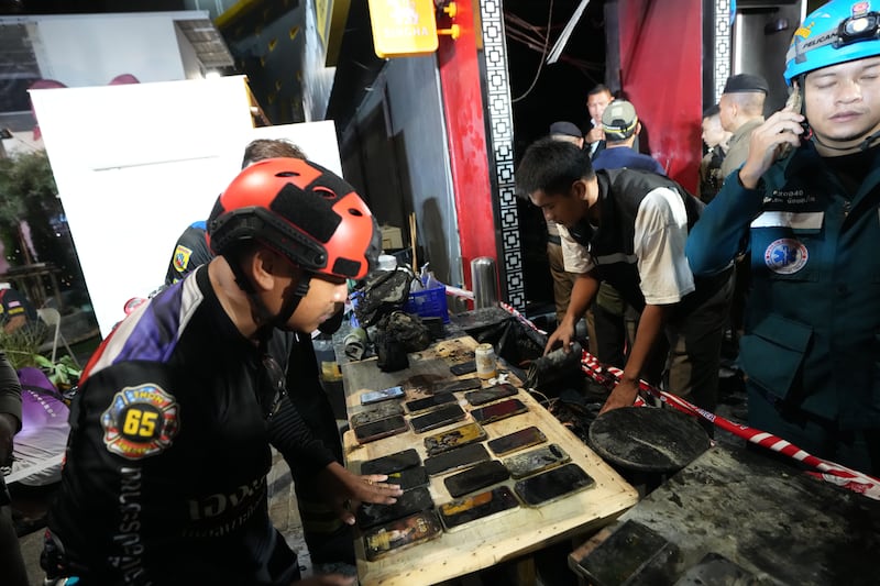 Emergency services personnel recovered mobile phones belonging to victims of the fire. Photograph: Sakchai Lalit/AP