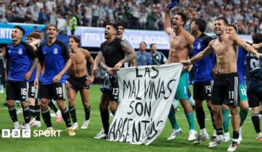 The Argentina players celebrate at full-time with a banner that reads "The Falkland Islands are Argentinian" during the World Cup 2026 semi-final between England and Argentina