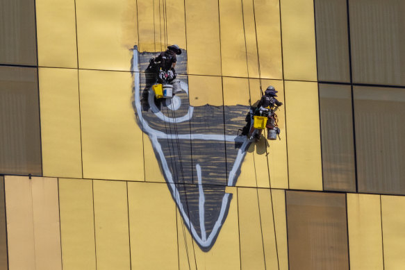 Pam the Bird graffiti being cleaned off Novotel, South Wharf, in February last year.