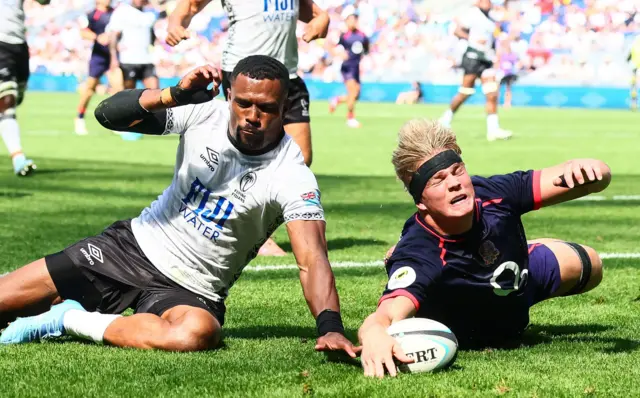 Henry Pollock wins the race to ground the ball for an England try against Fiji