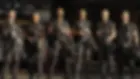 Six LAPD tactical officers in black gear pose with rifles in a dim garage, looking stern and ready.