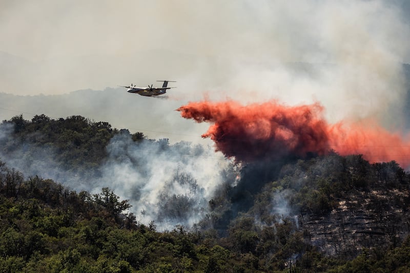 A civil security aircraft drops fire retardant over a wildfire near the town of Bouleternerre, France, on Monday. Photograph: Jc Milhet/AFP via Getty