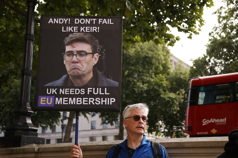 A demonstrator holds a sign on Whitehall as Andy Burnham is to become UK prime minister. Photograph: Alishia Abodunde/Getty Images