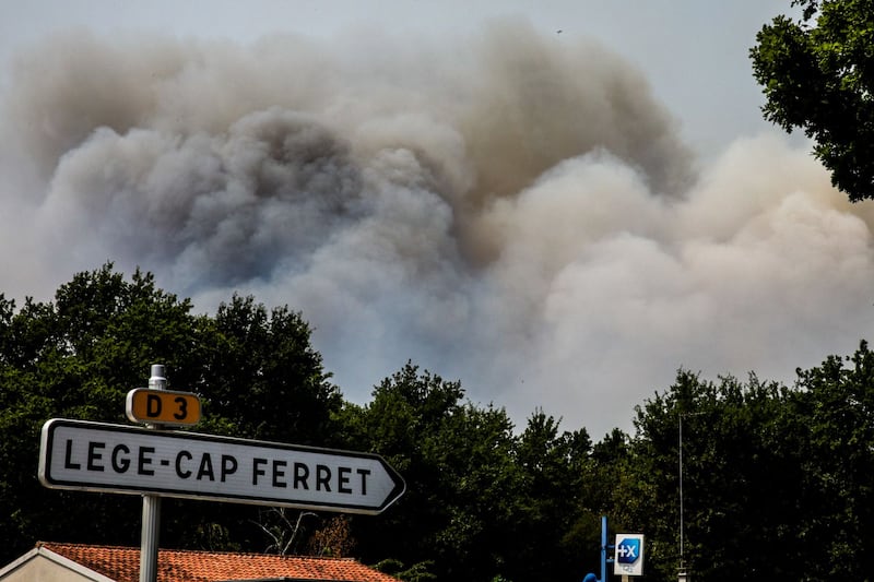 Smoke rises over a pine forest in Cap Ferret, southwestern France. Photograph: EPA