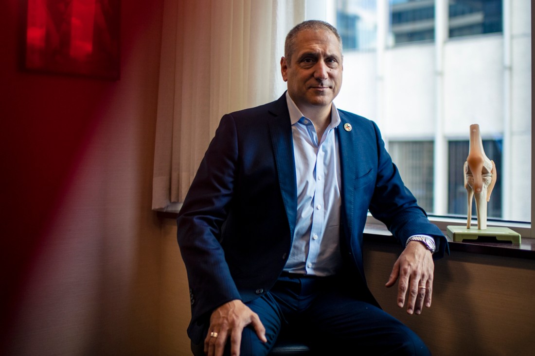 Gian Corrado leans against the windowpane for a portrait.