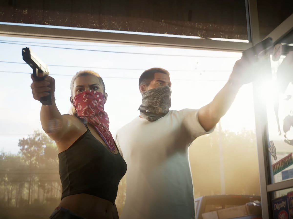 Lucia and partner in GTA VI trailer, both wearing bandanas and holding guns inside a sunlit store.
