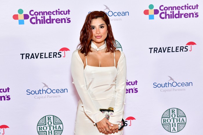 Diane Guerrero poses in a white dress on the red carpet at the Connecticut Children's Annual Gala
