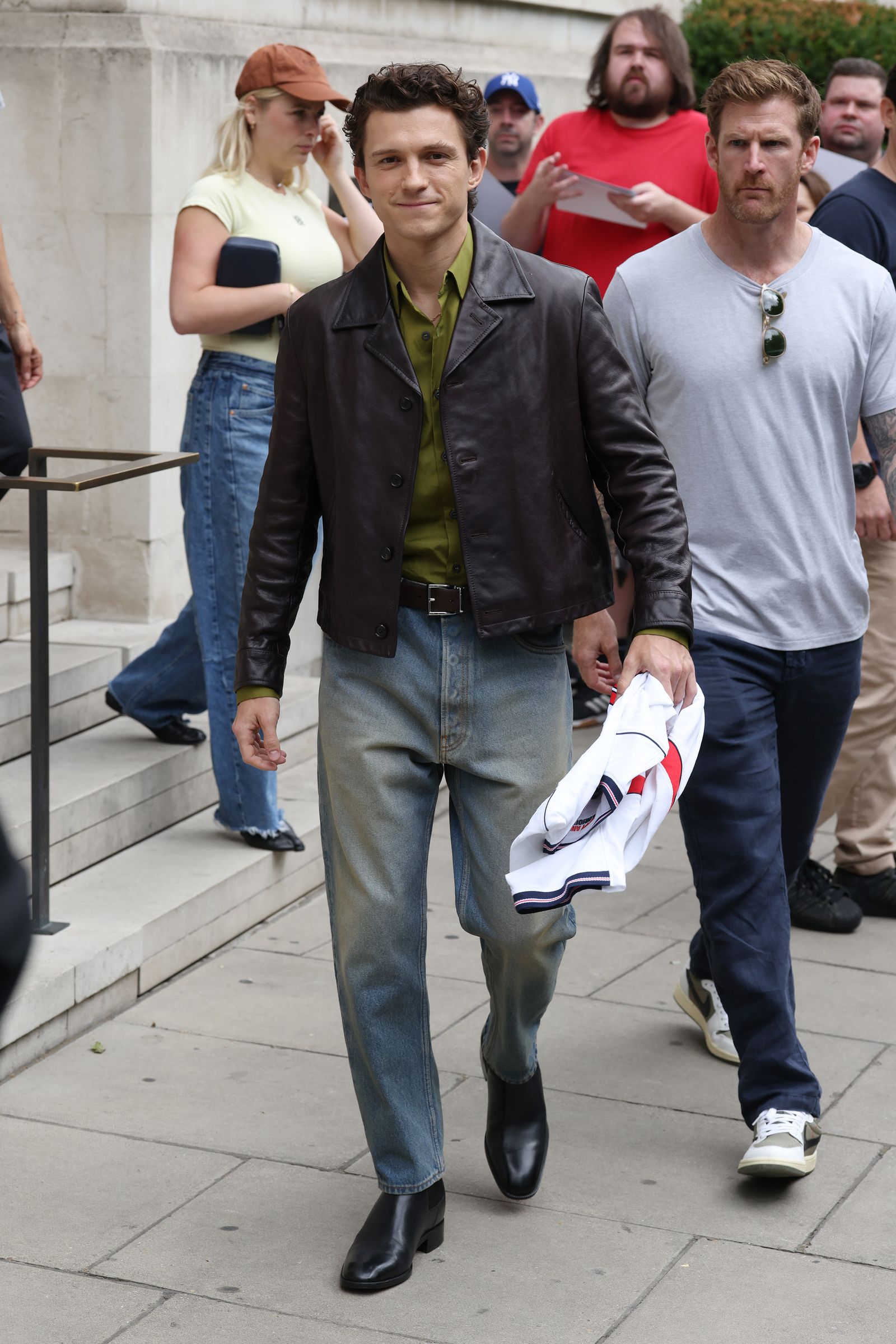 Image may contain Tom Holland Jarred Christmas John Caparulo Clothing Footwear Shoe Pants Sneaker Blazer and Coat