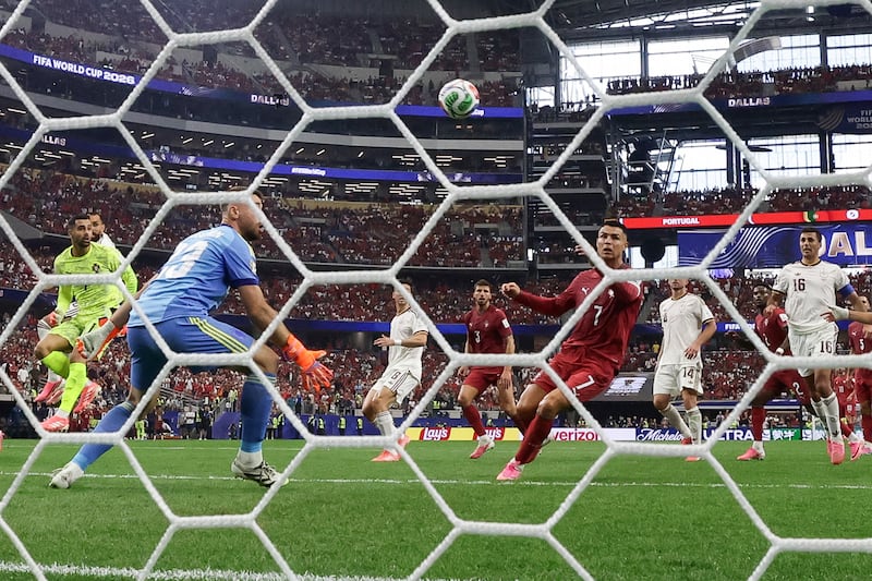 Ronaldo and Spain's goalkeeper Unai Simon look at the ball after a missed chance during the match. Photograph: Aric Becker/AFP via Getty