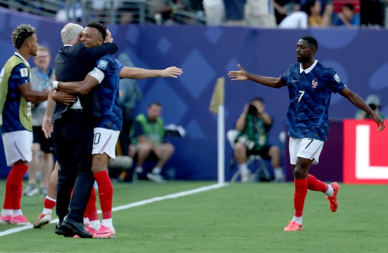 Kylian Mbappé of France celebrates with France's head coach Didier Deschamps after scoring the opening goal against Sweden. Photograph: Sarah Yenesel/EPA